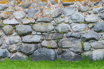 Medieval fortress- brick stone wall. Outdoor architecture- vintage rock