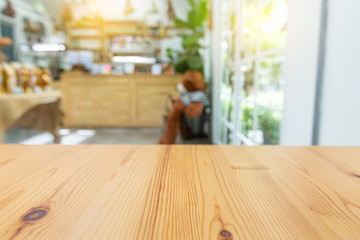 Empty wooden table space platform and blurred resturant or coffee shop background for montage product display.