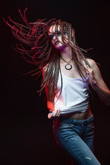 Emotional photo of a beautiful slim girl with creative make-up and a hairstyle of cornrows, wearing...