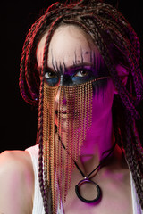 Beautiful young slim girl with creative make-up and a hairstyle of cornrows, wearing white t-shirt...