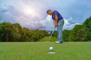 Fototapeta premium Golfer playing golf in beautiful golf course in the evening golf course with sunshine in thailand