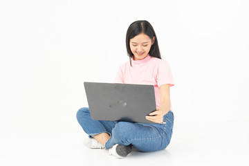Naklejka premium Happy asian teen passenger listening to the music with headphones while holding mobile phone.businesswoman listening to music with headphones while dancing isolated over white background