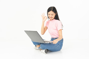 Happy asian teen passenger listening to the music with headphones while holding  mobile phone.businesswoman listening to music with headphones while dancing isolated over white background