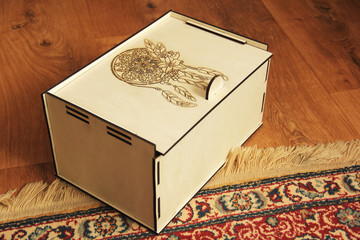 Wooden box on a background of wooden floor and carpet. Handmade box
