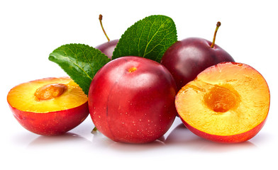Fresh plum in cut with green leaf. Fruity still life. Healthy food. Isolated on white background.