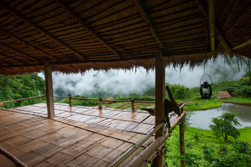 Looking outside the bamboo hut in the tropical jungle in foggy day