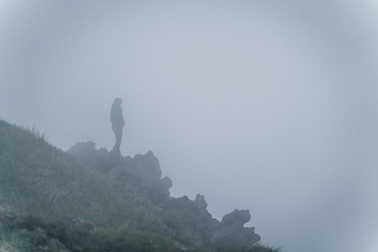 Guy doing hiking on the mountain in the fogh