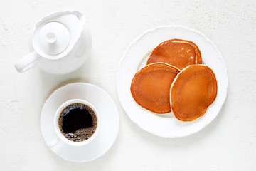 Healthy summer breakfast,homemade classic american pancakes with fresh berry and honey, morning light white stone background copy space top view