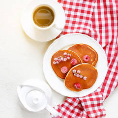 Healthy summer breakfast,homemade classic american pancakes with fresh berry and honey, morning light white stone background copy space top view