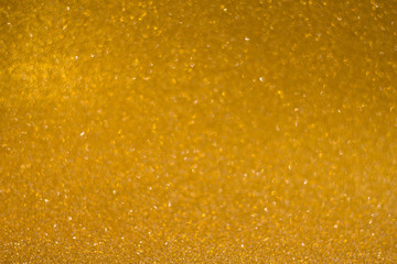 abstract blurred golden background with shiny bokeh