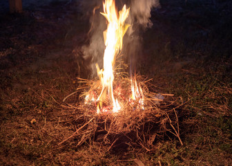 Fire on ground  with dry straw as fuel