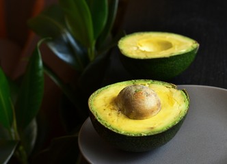 Two halves of avocado on a plate.