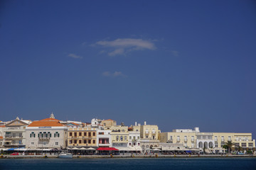 Fototapeta premium Hermoupolis, Syros, Greece: Hotels and cafes along the waterfront at the port of Syros, a Cyclades Island in Greece.