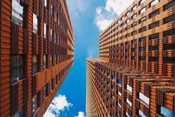 Look up view on orange skyscrapers in Amsterdam business district