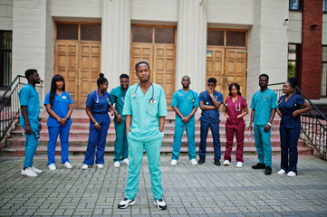 Group of african medical students posed outdoor against university door.