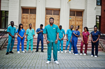 Group of african medical students posed outdoor against university door.