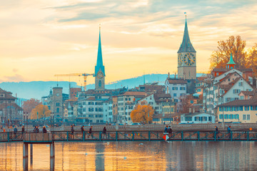 Obraz premium Zurich Switzerland busy people going on the bridge from or to the work with city and clock on the background on sunset