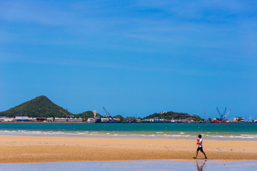 The beach and the background of the ship maintenance garage.