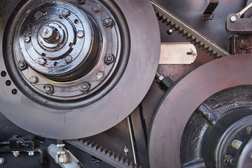 Belt drive with automatic belt tensioning mechanism. Fragment of a combine harvester