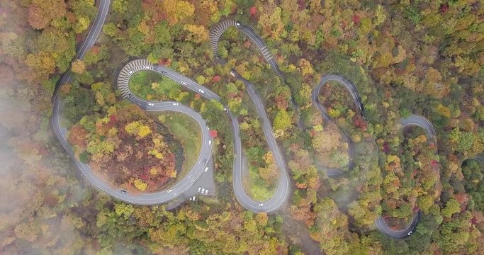 Aerial of car run on narrow and winding street (2nd Irohazaka route) in foliage starts changing color, Hosoomachi, Nikko, Tochigi.