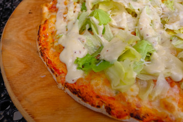 Close-up, two pieces of hot pizza with cheese  in a cafe on a wooden background.