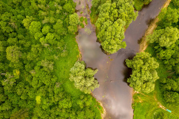 Aerial drone view of river cutting trough forest
