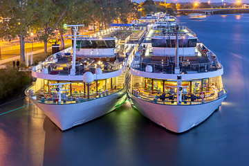 Avignon. Pleasure boats near the city promenade at sunset.