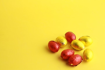 chocolate easter eggs, wrapped in yellow and red paper