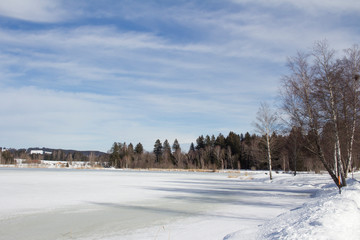 View in winter over the frozen lake Soier to the forest