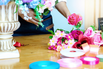 flower artist woman working to decorate  artificial flowers