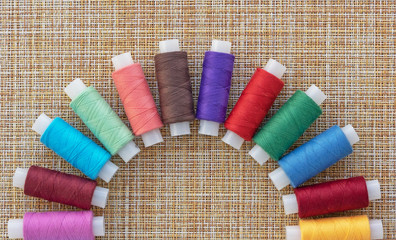Multicolored sewing threads. Spools of thread for sewing. The concept of sewing accessories.