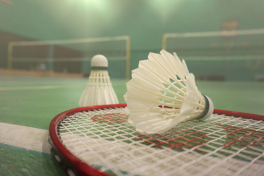 sports concept.Badminton ball (shuttlecock) and yonex racket ,badminton courts in background in Chonburi, Thailand.