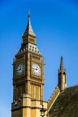 Fototapeta na wymiar Big ben clock tower seen from behind church, cloudless blue sky, London, England, UK