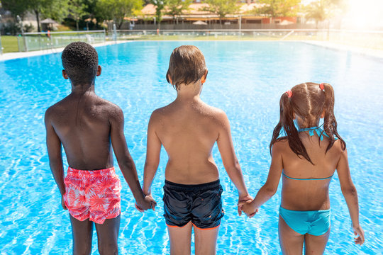 kids in the pool happy and smiling