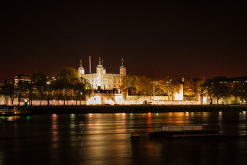 Tower of London at night, view across the River Thames, London, England