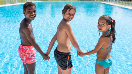 Fototapeta na wymiar kids in the pool happy and smiling