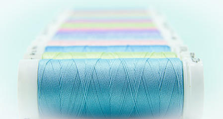 Sewing threads of different colors.