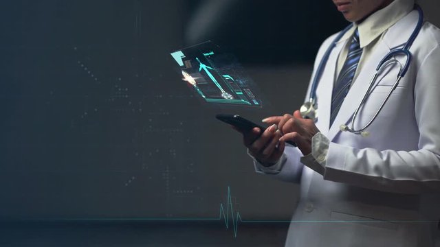 doctor holding smart device with holographic, digital futuristic virtual interface
