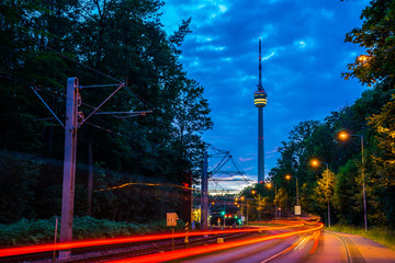 Germany, Television tower of stuttgart city called fernsehturm in magical twilight atmosphere after sunset with street full of traffic © Simon Dux Media