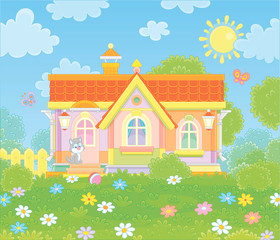 Colorful village house and a cute grey kitten watching funny butterflies flittering among flowers on green grass of a lawn on a sunny summer day, vector illustration in a cartoon style