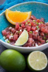 Closeup of tuna ceviche marinated in lime and orange juice, selective focus, vertical shot