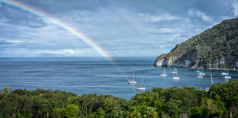 Naklejka na ściany i meble Deshaies bay in Guadeloupe with rainbow and boats