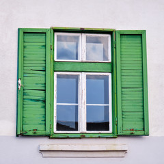 Fototapeta na wymiar Green, wooden window shutters in Sibiu, Romania. Square photo.