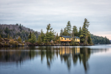 little cabin in front of a calm lake