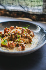 mushrooms sauteed in small white bowl.Grilled chicken breast with mushrooms