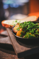 Roasted potato in a frying pan, close up view