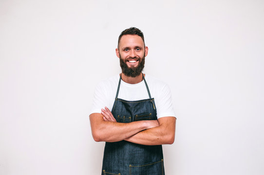 Portrait of a happy young crazy chef cook isolated on a white background