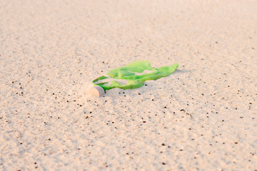 discarded crumpled plastic bottle in the sand