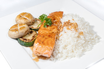 Stir pan fried salmon served with mushroom, zucchini and rice