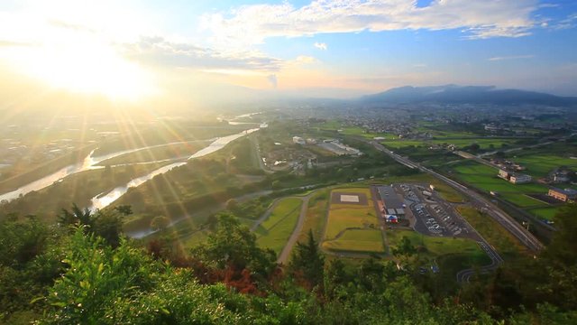Tilt up of Chikuma River, Ueda City and Uedahara at sunrise, Japan